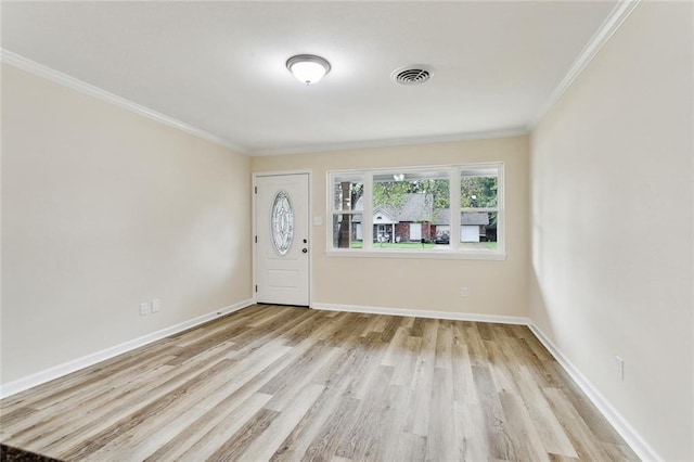 foyer with light hardwood / wood-style floors and ornamental molding