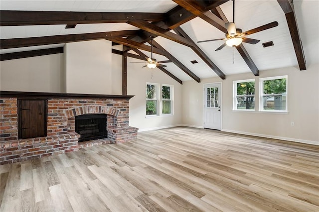 unfurnished living room with a brick fireplace, light hardwood / wood-style floors, and plenty of natural light