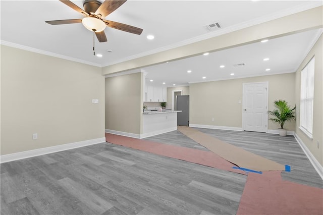 unfurnished living room with hardwood / wood-style floors, ceiling fan, and crown molding