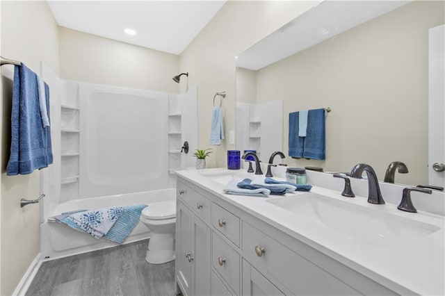 full bathroom featuring bathing tub / shower combination, vanity, hardwood / wood-style flooring, and toilet