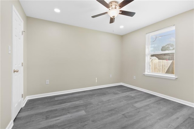 unfurnished room featuring ceiling fan and dark hardwood / wood-style floors