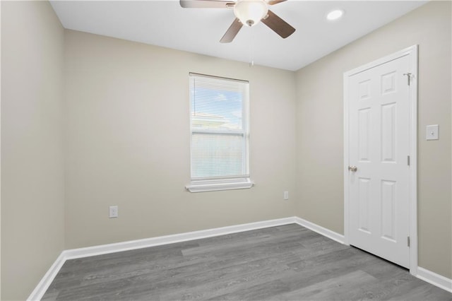 spare room featuring hardwood / wood-style flooring and ceiling fan