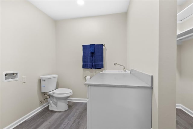 bathroom with vanity, hardwood / wood-style flooring, and toilet