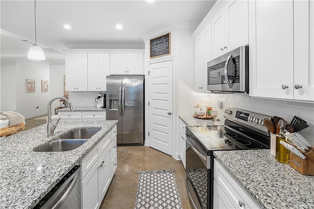 kitchen featuring light stone counters, appliances with stainless steel finishes, decorative light fixtures, sink, and white cabinets