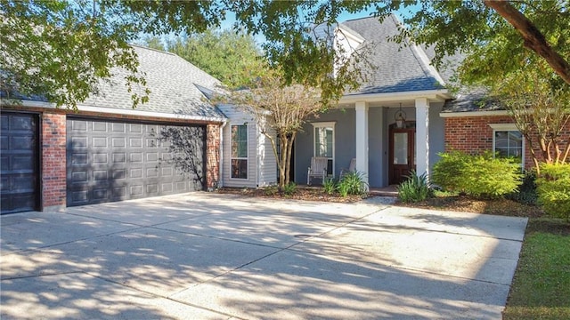 view of front of home with a garage and a porch