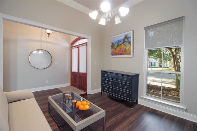 living room with dark wood-type flooring and a chandelier