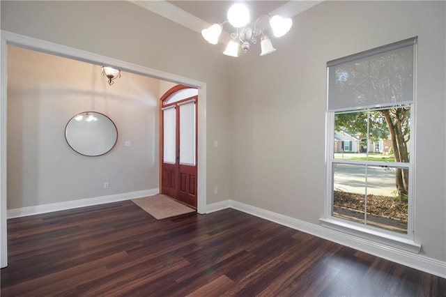 entrance foyer with a chandelier and dark hardwood / wood-style floors