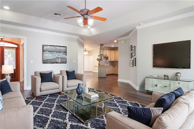 living room with ceiling fan, crown molding, and dark hardwood / wood-style flooring