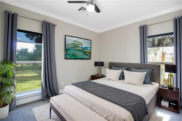 bedroom with crown molding, light colored carpet, multiple windows, and ceiling fan