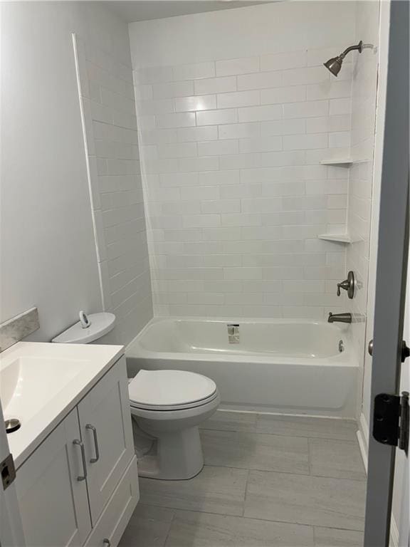 full bathroom with vanity, toilet, and tiled shower / bath combo