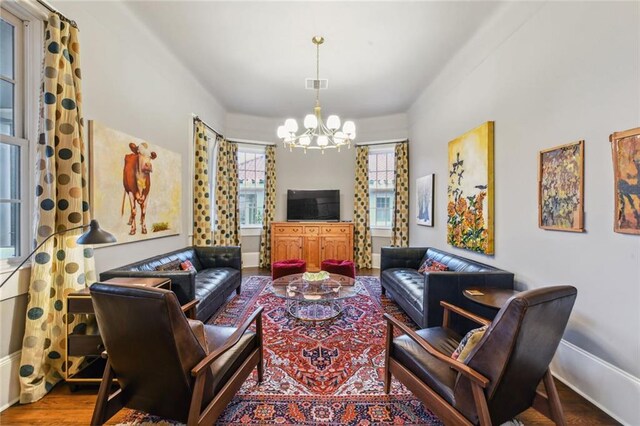 living room featuring hardwood / wood-style flooring and a chandelier