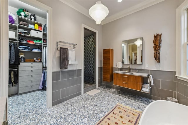 bathroom with vanity, ornamental molding, tile walls, and independent shower and bath