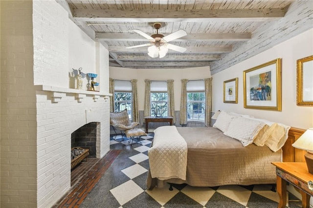 bedroom with beam ceiling, ceiling fan, a fireplace, and wooden ceiling