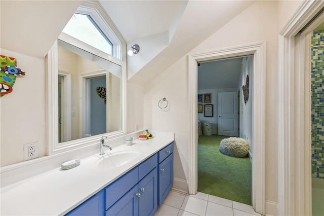 bathroom with tile patterned floors, vanity, and lofted ceiling