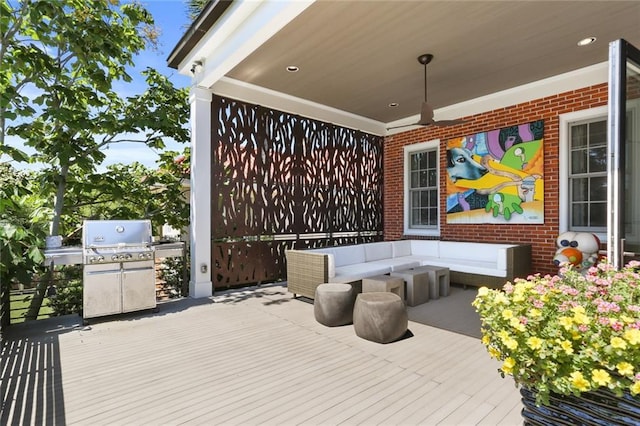 wooden terrace featuring an outdoor living space and area for grilling