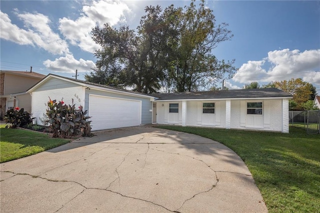 ranch-style home featuring a front lawn and a garage