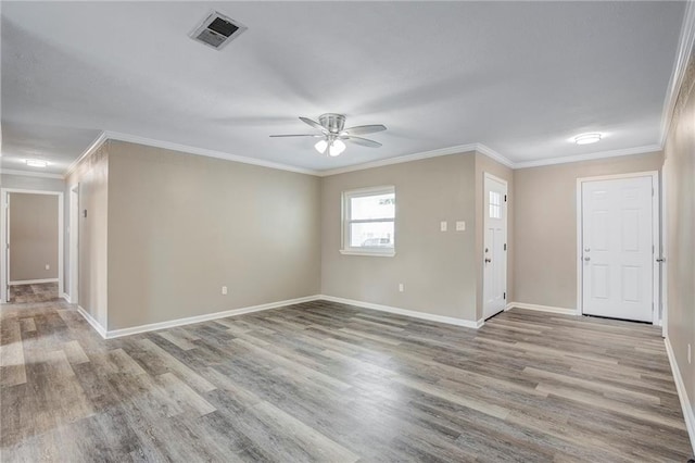 interior space featuring light wood-type flooring, ceiling fan, and crown molding