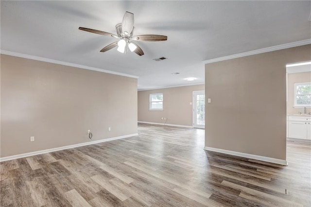 unfurnished room with hardwood / wood-style flooring, crown molding, sink, and ceiling fan