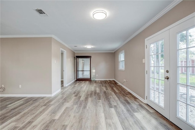 unfurnished room with light hardwood / wood-style floors, crown molding, and french doors