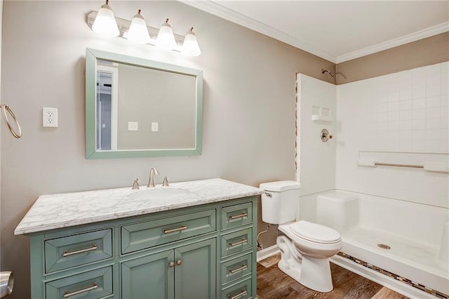 bathroom with ornamental molding, walk in shower, vanity, hardwood / wood-style floors, and toilet