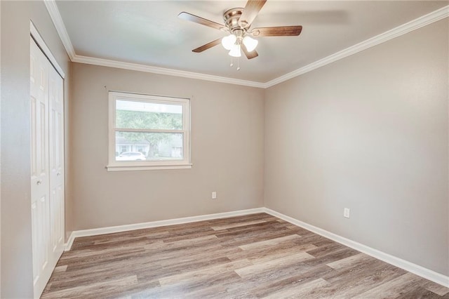 unfurnished room with ceiling fan, light hardwood / wood-style flooring, and ornamental molding