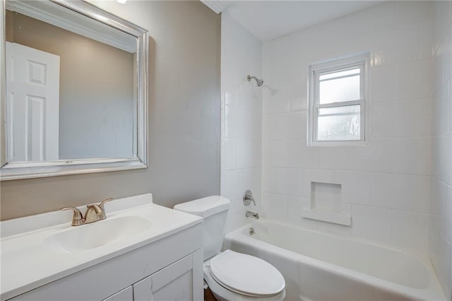 full bathroom featuring vanity, tiled shower / bath combo, and toilet