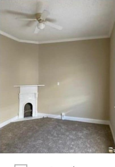 unfurnished living room featuring ceiling fan, carpet flooring, and crown molding