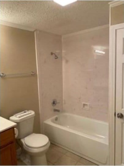 full bathroom with tile patterned flooring, a textured ceiling, vanity, toilet, and tiled shower / bath combo