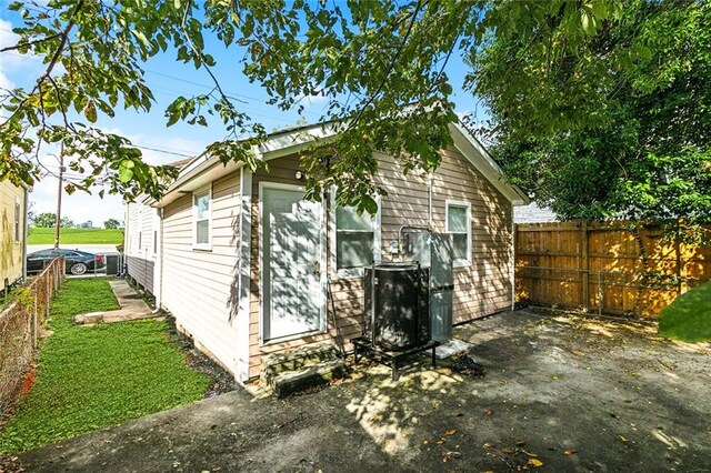 view of side of home featuring central AC unit