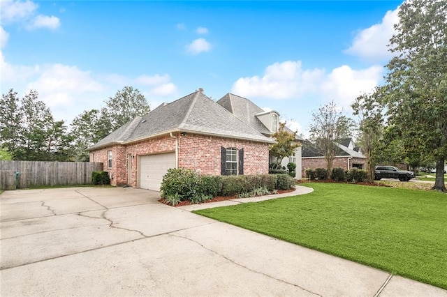 view of home's exterior with a garage and a lawn