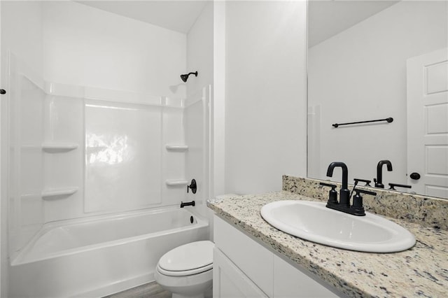 full bathroom with toilet, vanity, hardwood / wood-style flooring, and shower / washtub combination