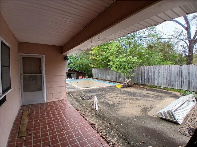 view of patio with a fenced in pool