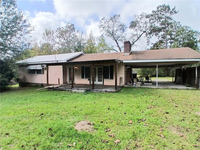 back of house featuring a deck and a yard