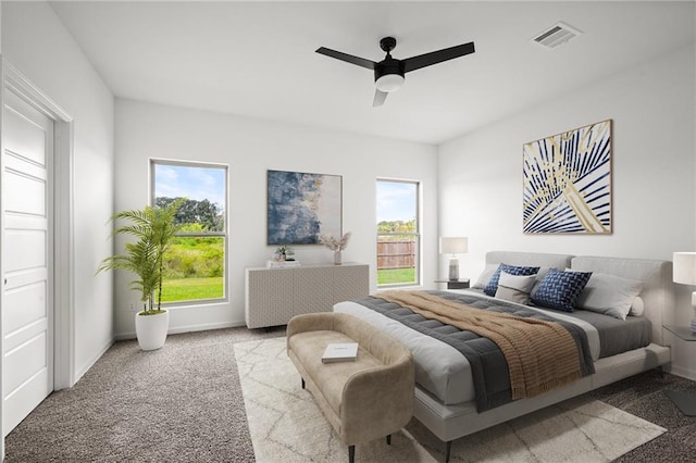 bedroom with visible vents, a ceiling fan, baseboards, and carpet floors