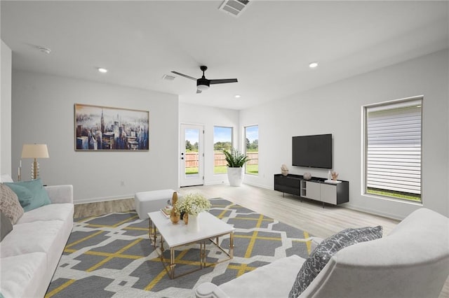living room with recessed lighting, wood finished floors, ceiling fan, baseboards, and visible vents