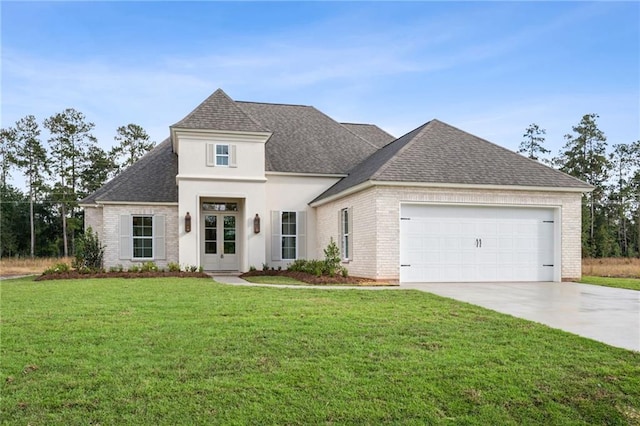 view of front of home featuring a garage and a front lawn