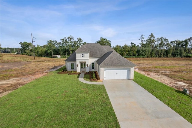 view of front of property featuring a front lawn and a garage