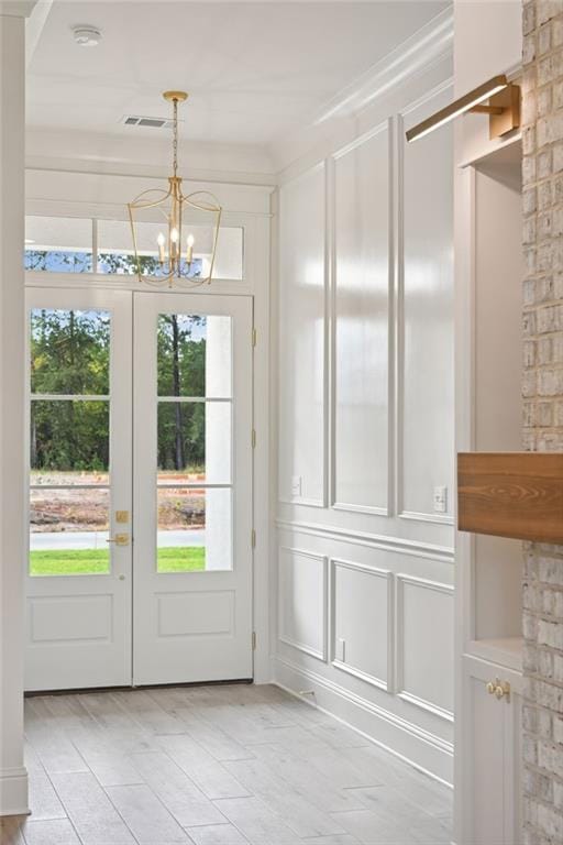 doorway featuring french doors and a notable chandelier