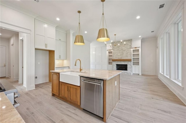 kitchen with white cabinetry, light stone counters, stainless steel dishwasher, an island with sink, and pendant lighting