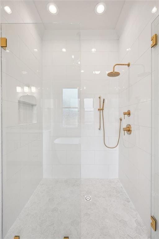 bathroom featuring a shower with shower door