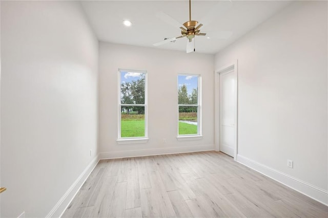 empty room featuring ceiling fan and light hardwood / wood-style flooring