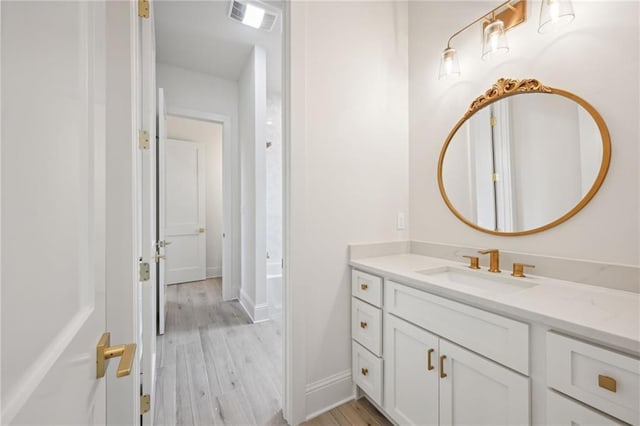 bathroom with hardwood / wood-style flooring and vanity