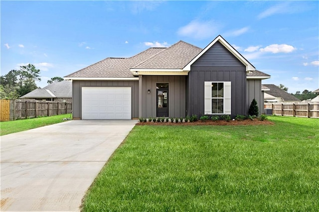 view of front of house with a garage and a front lawn