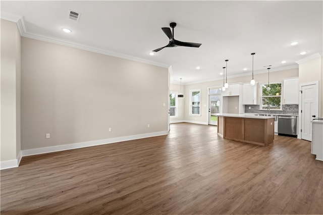 kitchen featuring a kitchen island, stainless steel dishwasher, dark hardwood / wood-style floors, and white cabinets