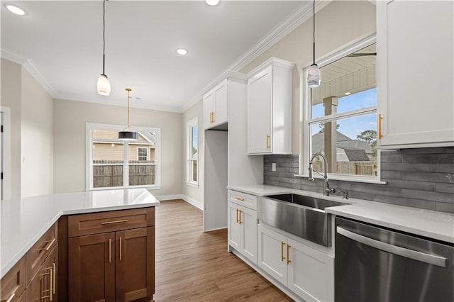 kitchen with backsplash, pendant lighting, light hardwood / wood-style floors, white cabinets, and stainless steel dishwasher