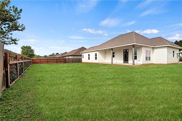 back of house featuring a patio and a lawn