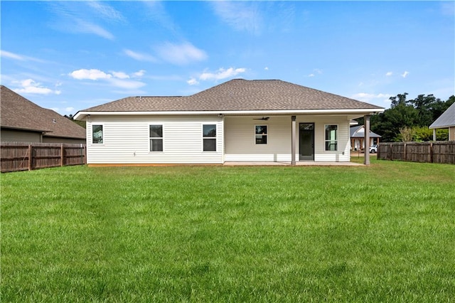 rear view of house with a yard