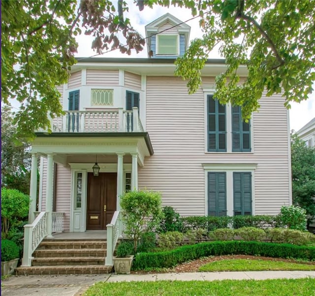 view of front of house with a balcony and covered porch