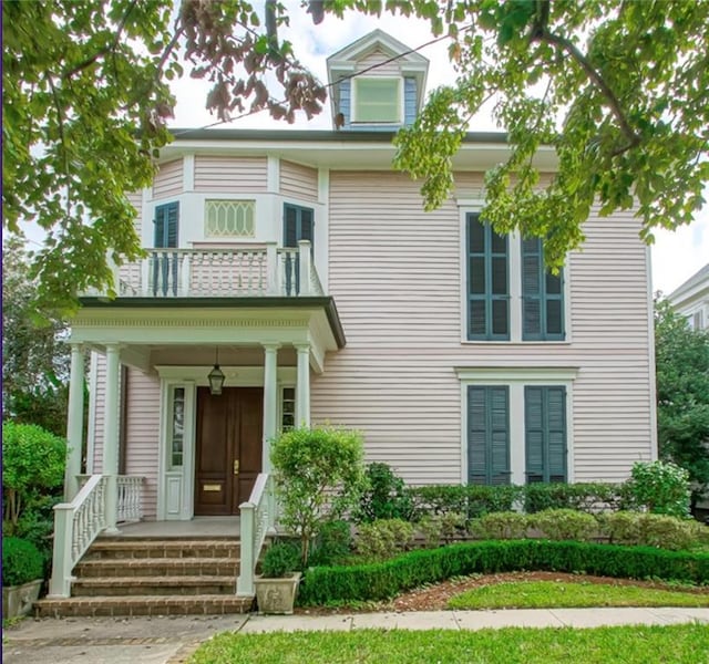 1521 Dufossat St, New Orleans, LA 70115 - view of front of house with a balcony and covered porch
