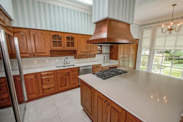 kitchen featuring appliances with stainless steel finishes, pendant lighting, an inviting chandelier, sink, and custom exhaust hood